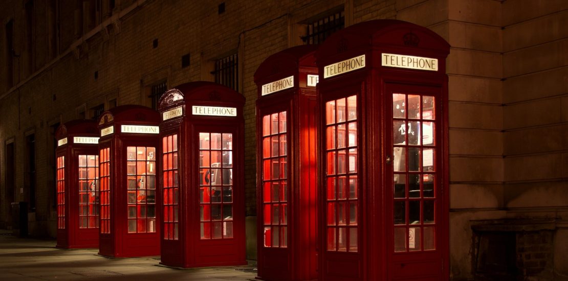 five red lined phone booths near building
